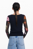 back of t-shirt on a woman with a braid and wearing jeans