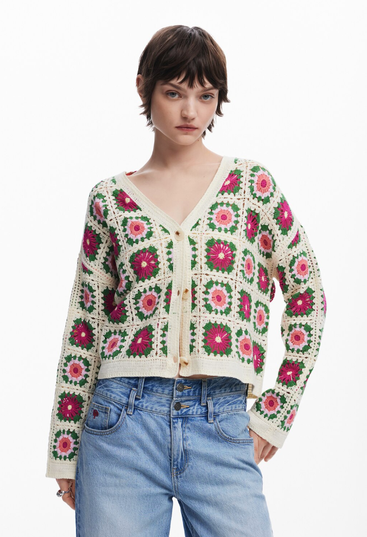 model in v-neck cardigan composed of crochet multi-color squares