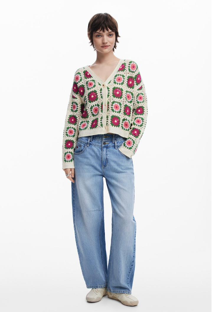 model in crochet-square sweater with hand in jeans pocket